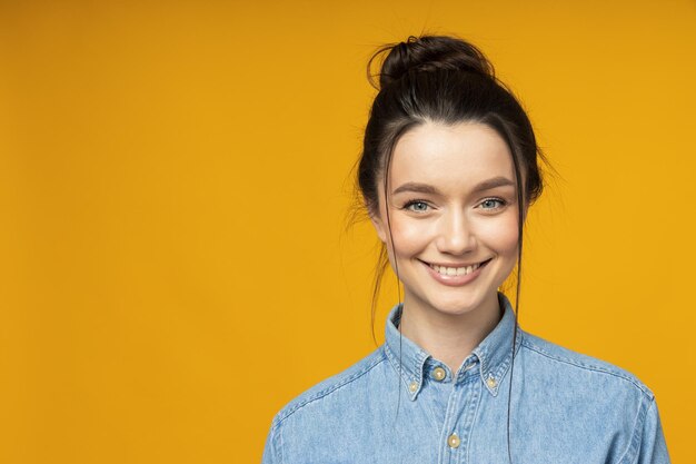 Young woman in a denim shirt hair tied up