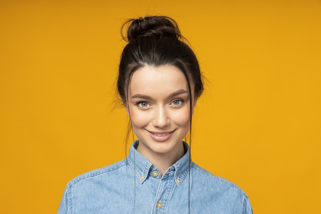 Young woman in a denim shirt hair tied up