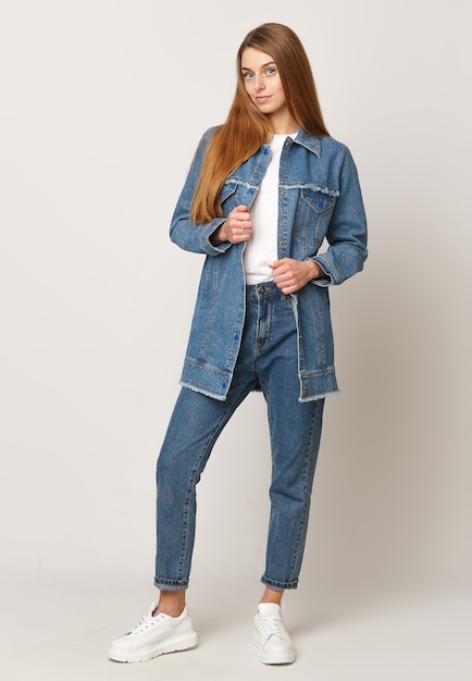 Photo young woman in denim suit on a white background. concept of advertising photo for clothing.