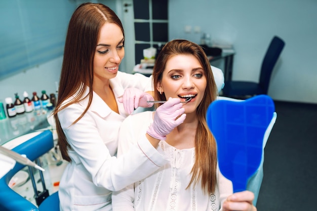 Young woman at the dentist's chair during a dental procedure Overview of dental caries prevention