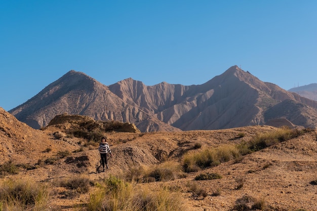 A young woman in the desert of Tabernas, AlmerÃÂÃÂ­a province, Andalusia. On a trek in the Rambla del Infierno