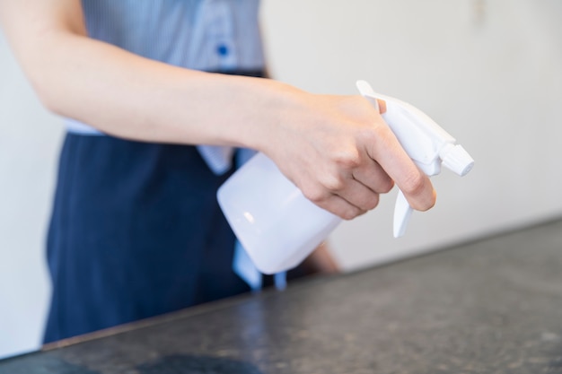 Young woman disinfectant with alcohol spray