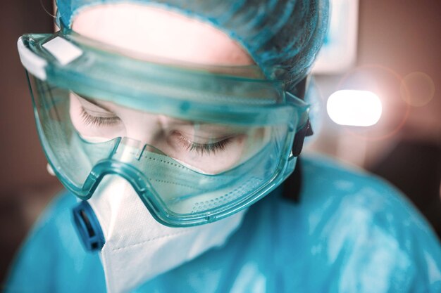 young woman doctor laboratory assistant in goggles in medic uniform