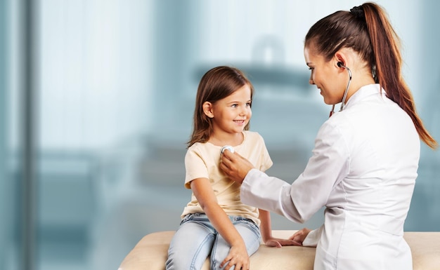 Young woman doctor with little girl in