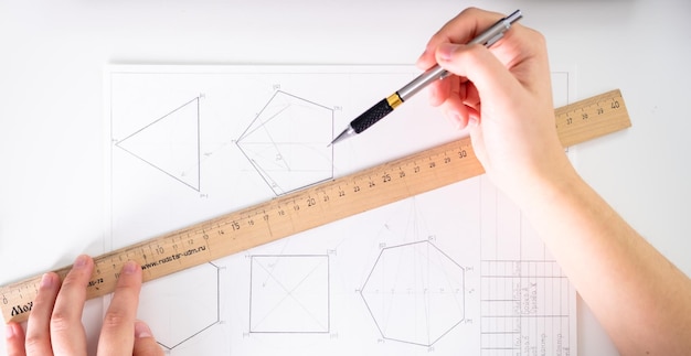 A young woman does her mechanical drawing homework mechanical\
drawing education technical drawings a young woman learns to draw\
and masters the profession of a mechanical draftsman