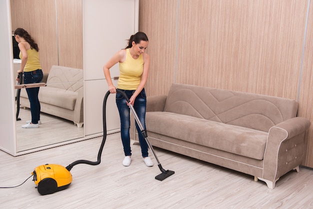 Young woman doing cleaning at home