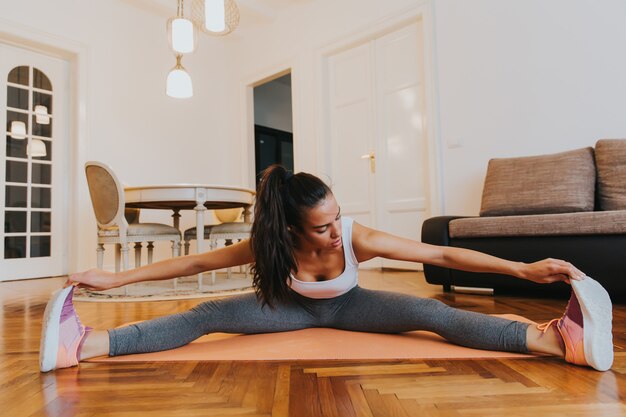 Young woman doing exercise in the room