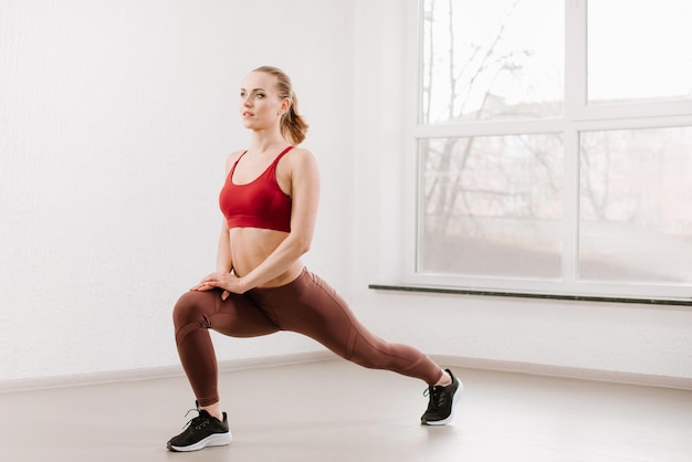 Young woman doing exercises at the gym