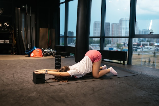 Young woman doing exercises in the gym