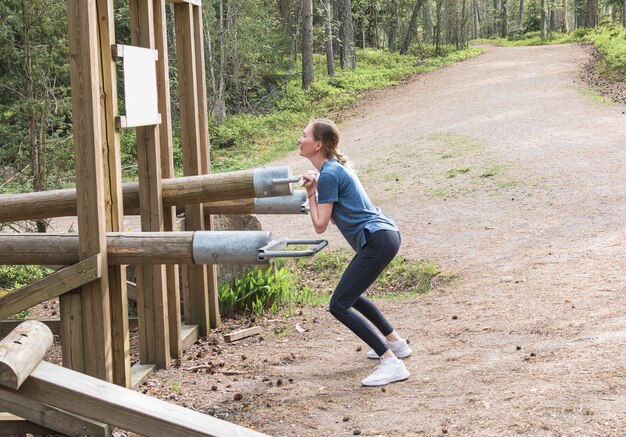 young woman doing exercises in nature