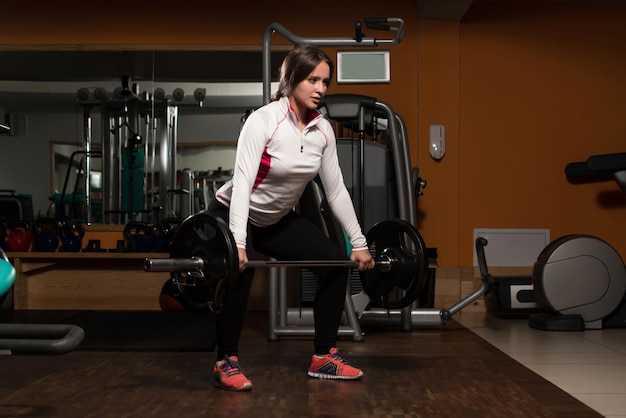 Young Woman Doing Heavy Weight Exercise For Back