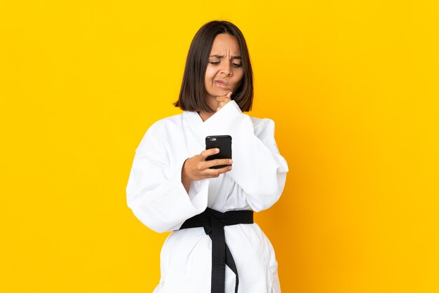 Young woman doing karate isolated