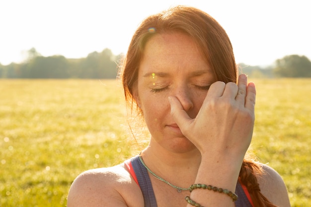 Young woman doing meditation exercises outdoors