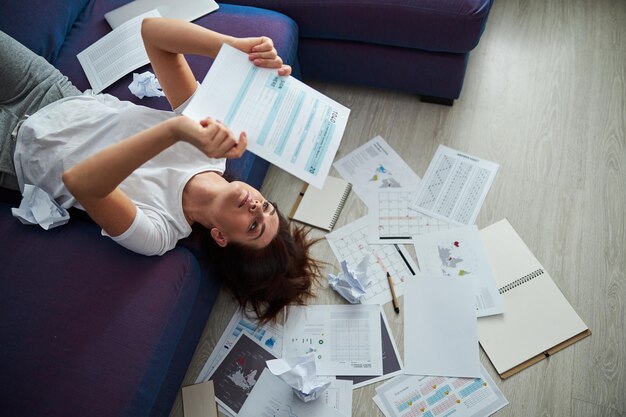 Young woman doing paperwork at home during quarantine