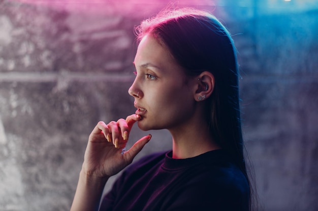 Young woman doing piercing at beauty studio salon