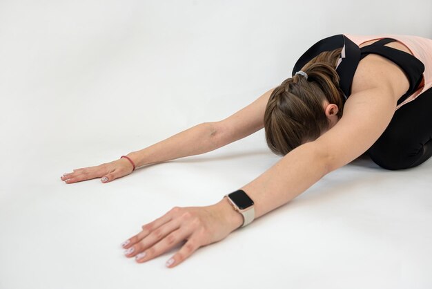 Young woman doing streching exercise isolated on white background