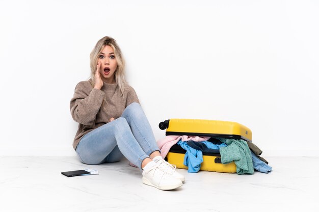 Young woman doing a suitcase