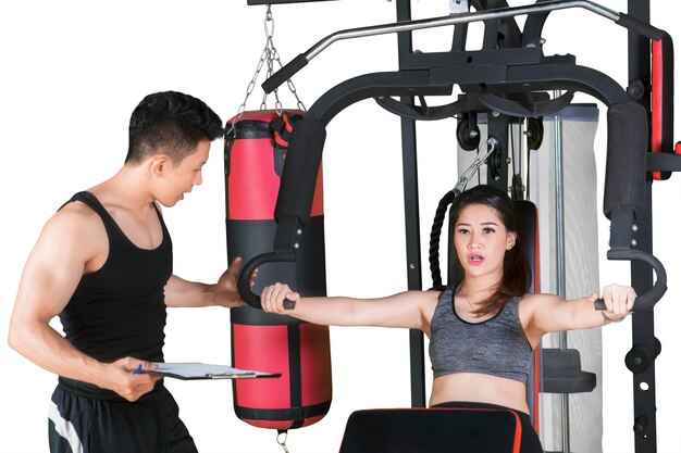 Young woman doing a workout with her trainer