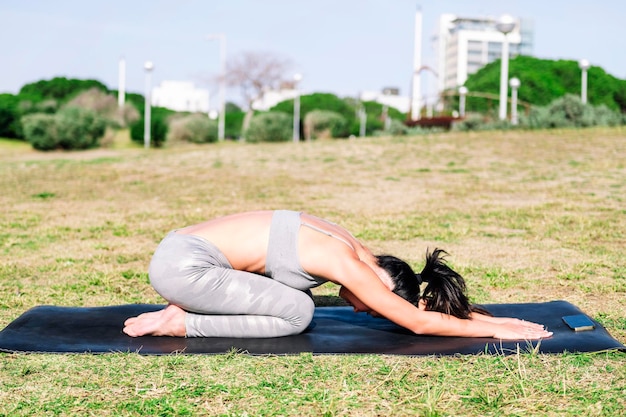 Young woman doing yoga back stretching exercises