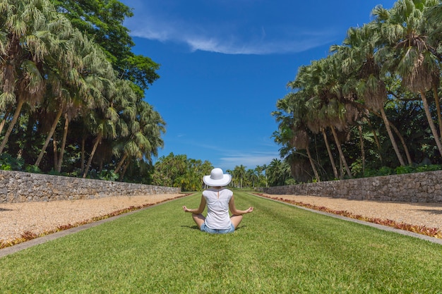 Young woman doing yoga exercises in park