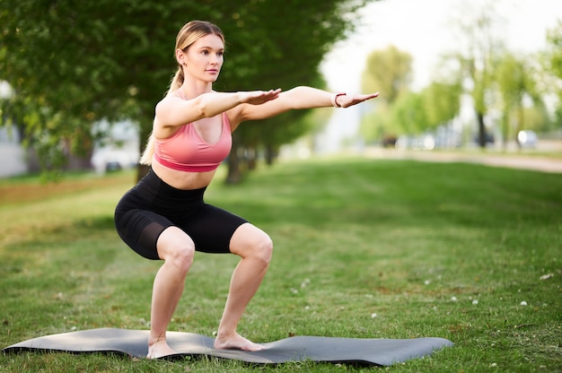 Young woman doing yoga exercises in the park