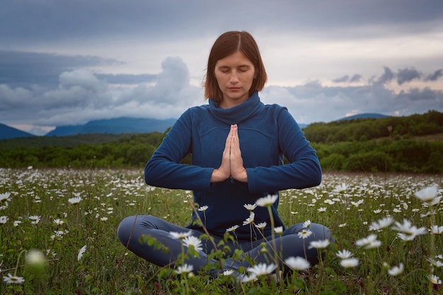 A young woman doing yoga in the field