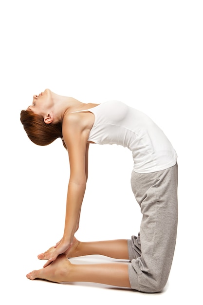 Young woman doing yoga isolated against white background