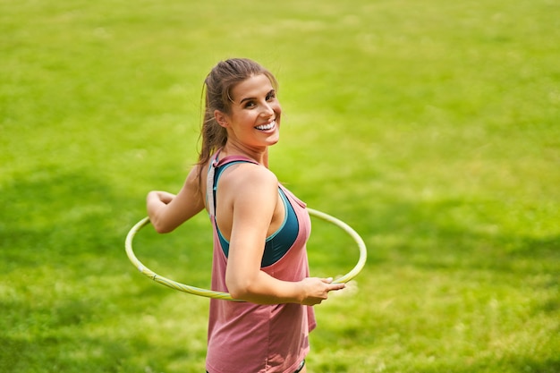 Young woman doing yoga in morning park