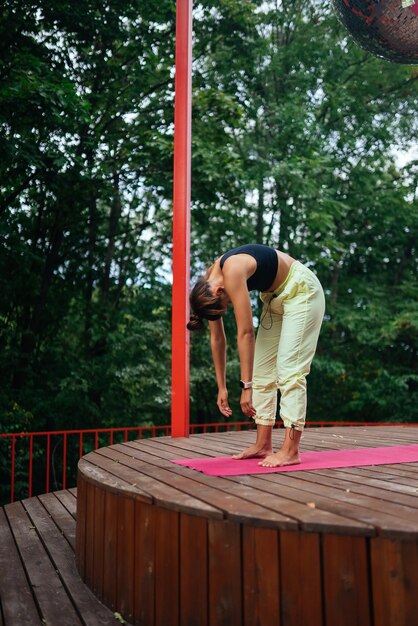 A young woman in doing yoga in the yard