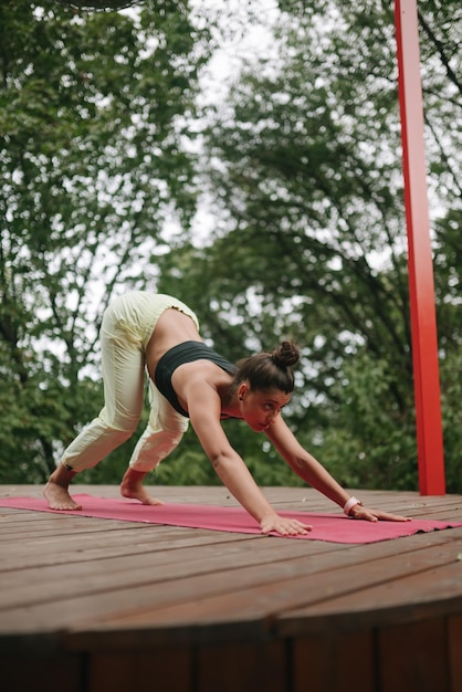 A young woman in doing yoga in the yard