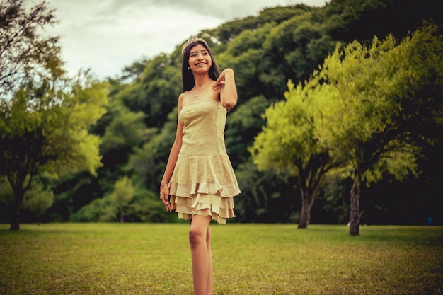 Young woman in dress possing at nature landscape