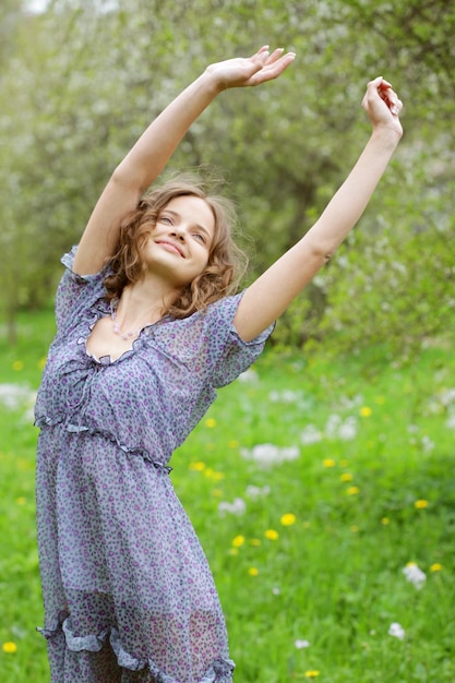 Young woman in dress relaxing in garden