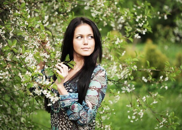 Young woman in dress relaxing in garden