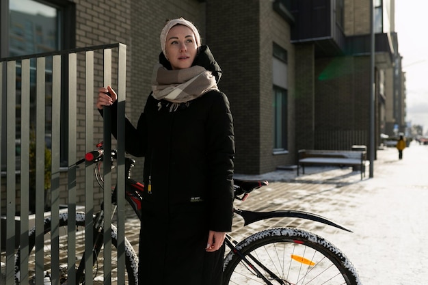 A young woman dressed for winter rented a bicycle for the weekend