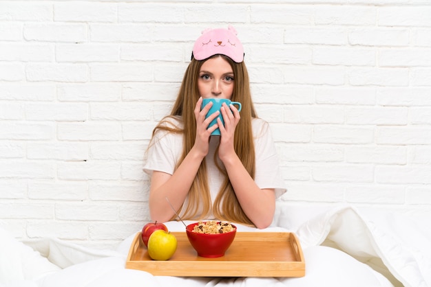 Young woman in dressing gown in bed