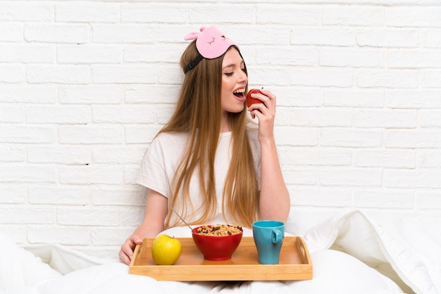 Young woman in dressing gown in bed