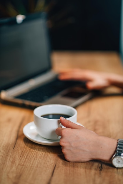 Young woman drinking coffee and working at home