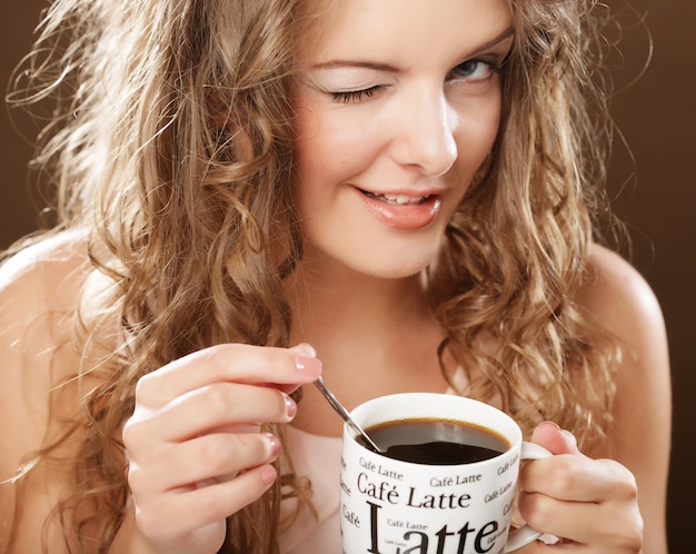 Giovane donna che beve il caffè