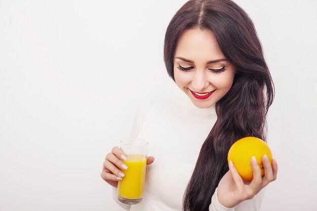 Young woman drinking fresh orange juice