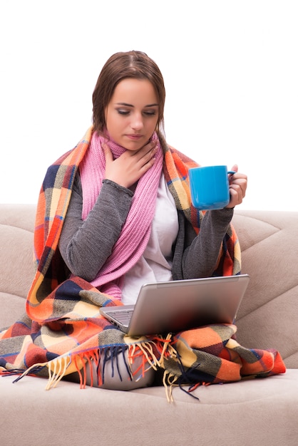 Young woman drinking tea during fever