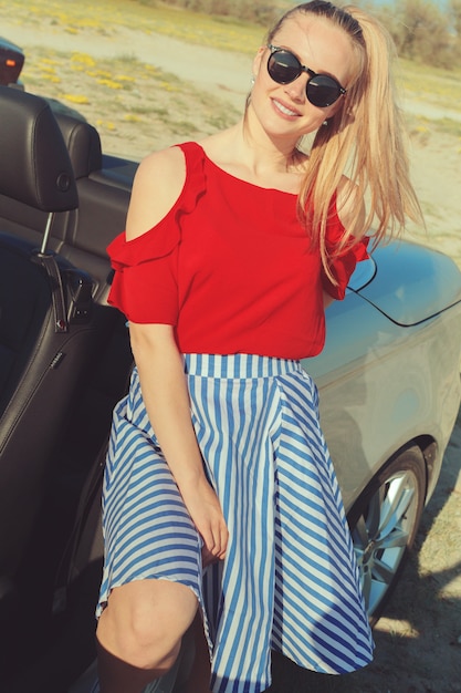 Young woman drive a car on the beach