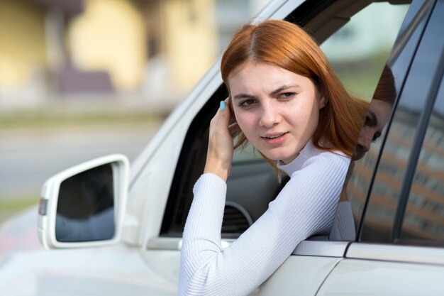 young woman driver looking out of a car window