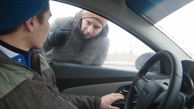 Young woman driver sitting in the car and looking on the mirror