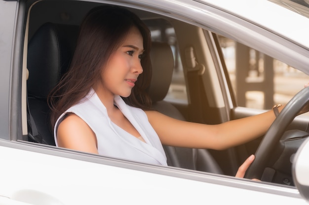 Young woman driving a car.