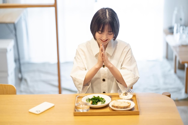 Young woman eating breakfast in the room