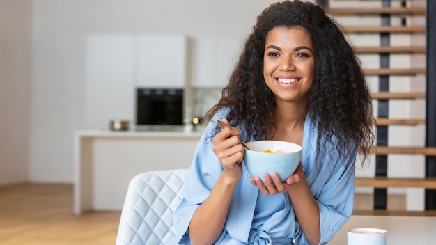 Young woman eating cereals