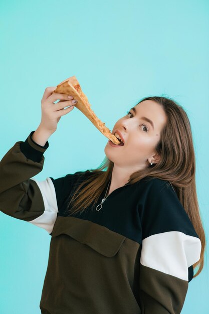 young woman eating pizza