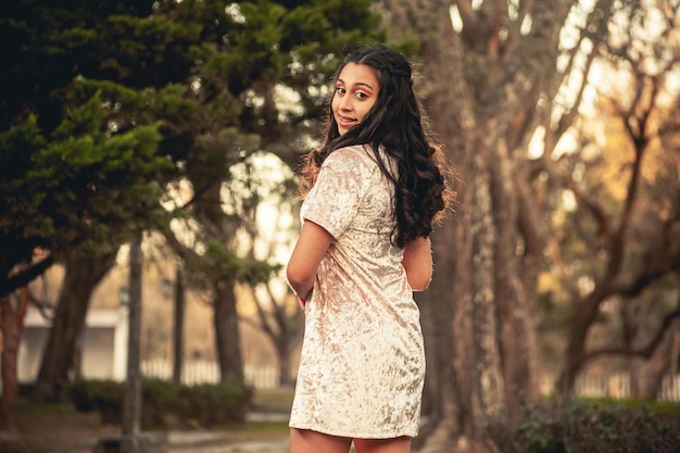 Young woman in elegant dress in a forest