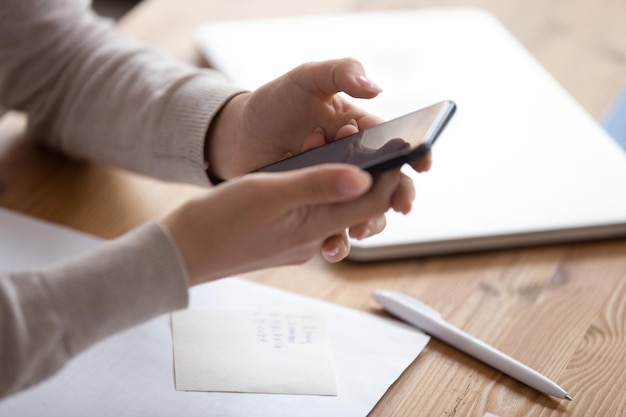 young woman engages in notetaking at workspace
