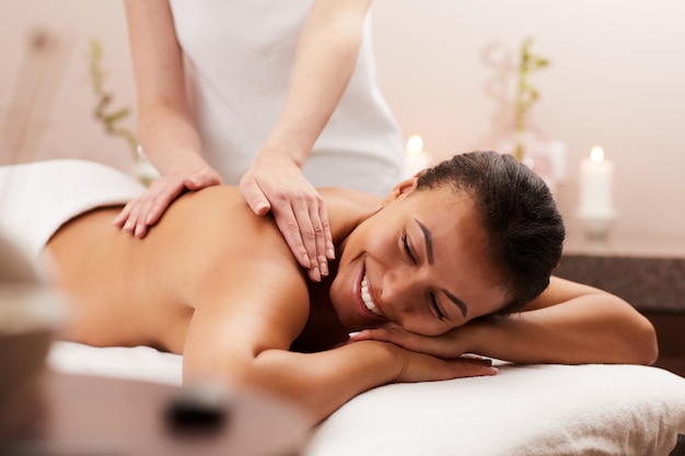 Young woman enjoying back massage